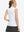 Back upper body shot of model wearing white women's athletic quarter zip tank tops