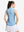 Back upper body shot of model wearing blue white women's q-zip pin striped texture golf shirts
