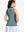 Back upper body shot of model wearing dusty blue women's collared v neck quick dry tank tops