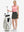 Front full body shot of model with golf gear wearing dark grey women's stretch a-line golf skort with 7 pockets