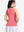 Back upper body shot of model wearing pink women's collared v neck quick dry tank tops