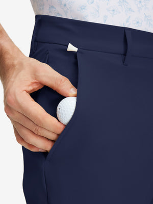 Detail view of side pocket on dark blue stretch cotton blend slim fit golf trousers 5 pockets