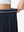Detail view of elastic waistband on navy blue women's moisture-wicking athletic tennis skirts