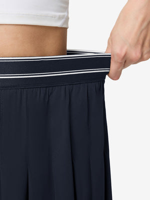 Detail view of elastic waistband on navy blue women's moisture-wicking athletic tennis skirts