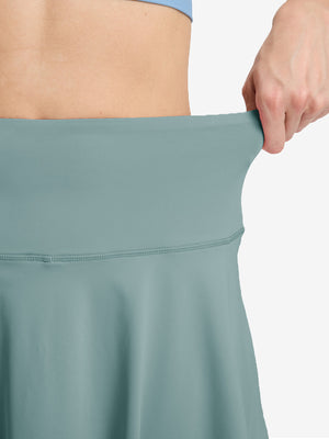 Detail view of skirt elasticity on dusty blue women's high waisted golf skirts with 4 inner pockets