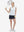 Front full body shot of model playing golf in white blue florals women's sleeveless v-neck print golf shirts