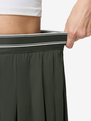 Detail view of elastic waistband on army green women's moisture-wicking athletic tennis skirts