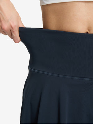 Detail view of skirt elasticity on navy blue women's high waisted golf skirts with 4 inner pockets