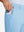 Hand placing an iPhone into pocket of soft lightweight casual golf pants with 5 pockets in light blue.