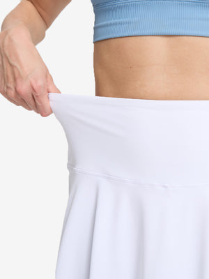 Detail view of skirt elasticity on white women's high waisted golf skirts with 4 inner pockets