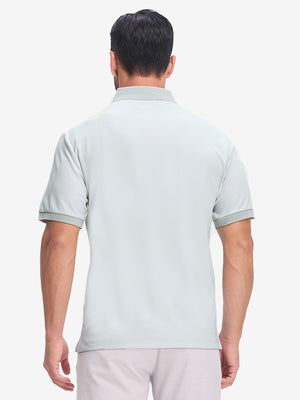 Back upper body shot of model wearing light grey moisture wicking jacquard golf shirts