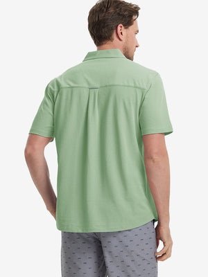 Model half-body back view wearing light green cotton blend plain shirt.