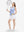 Front full body shot of model playing golf in white blue stripes women's sleeveless v-neck print golf shirts