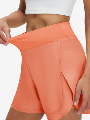 Detail view of elastic waistband on peach pink women's gym golf shorts with liner pocket