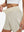 Detail view of elastic waistband on oyster gray women's gym golf shorts with liner pocket