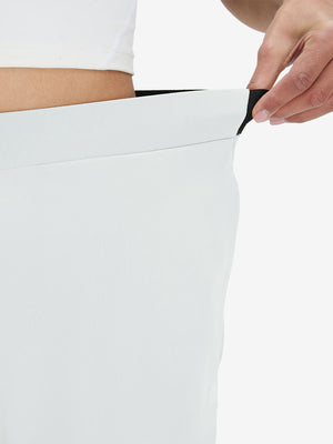 Detail view showing waist stretch on white women's lightweight athletic sweatpants