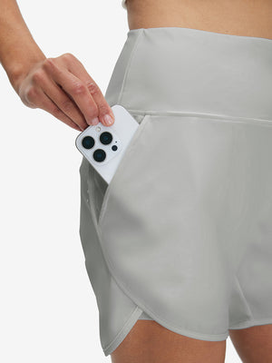 Side view of pocket on glacier grey women's high waist 2 in 1 quick dry shorts with 7 pockets