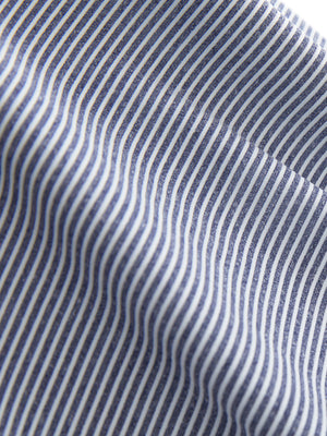 Close-up texture of navy white women's q-zip pin striped texture golf shirts fabric showing pin striped weave detail.