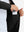 Hand placing iPhone into inner pocket of lightweight water-resistant outerwear jacket in black