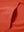 Close-up of single pocket detail on youth long sleeve hoodied with kangaroo pocket in orange, showing stitching.