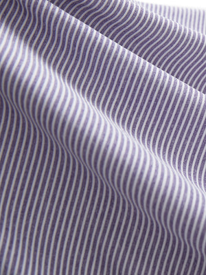 Close-up texture of light purple white women's q-zip pin striped texture golf shirts fabric showing pin striped weave detail.