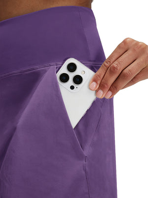 Detail view of side pocket on dark purple women's stretch a-line golf skort with 7 pockets