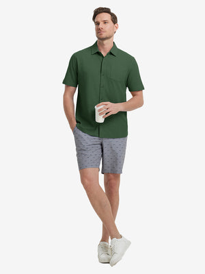 Full-body view of model holding takeaway drink cup in dark green cotton blend plain shirt.
