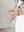 Detail view of outer pocket on khaki grey waterproof lightweight rain jacket with hood