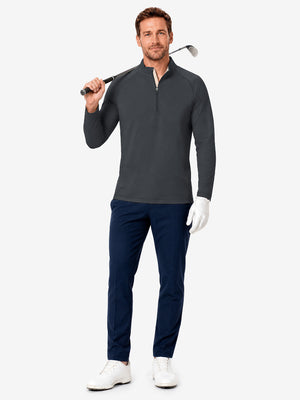 Full body model holding golf equipment for shooting, dry fit athletic 1/4 zip sweatshirt in black heather