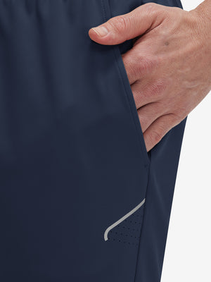Side view of pocket on navy 4 way stretch breathable workout athletic shorts