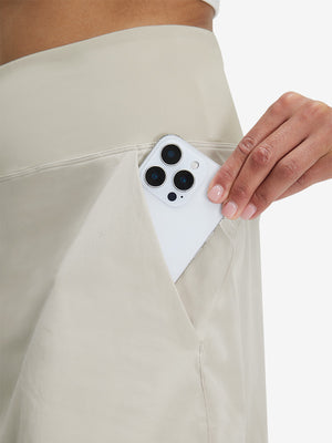 Detail view of side pocket on oyster gray women's stretch a-line golf skort with 7 pockets