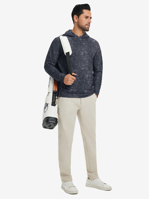 Model carrying a golf bag while wearing exclusive print kangaroo hoodies in navy, full-body shot.