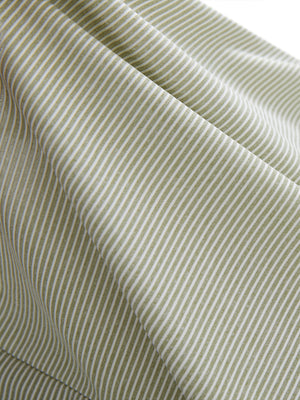 Close-up texture of moss green white women's q-zip pin striped texture golf shirts fabric showing pin striped weave detail.