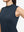 Detail view of armhole on navy blue women's moisture-wicking mock neck sleeveless golf tops