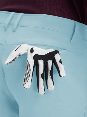 Detail view of back pocket on light blue flat front hybrid golf shorts