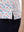 Detail view of hem on colorful hearts women's sleeveless v-neck print golf shirts