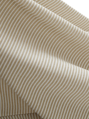 Close-up texture of beige white women's q-zip pin striped texture golf shirts fabric showing pin striped weave detail.