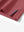 Detail view of hem on brick red dry fit waffle textured collared golf shirts