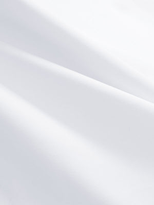Close-up texture of white women's athletic quarter zip tank tops fabric showing detailed athletic material and weave.