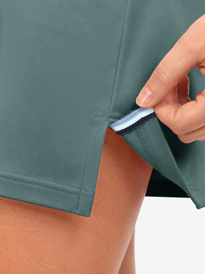 Hem stitching detail close-up in dusty blue of women's lightweight golf dress with 2 pockets.