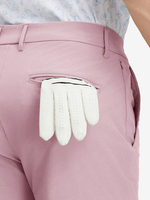Detail view of back pocket on pink stretch cotton blend slim fit golf trousers 5 pockets