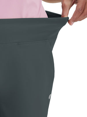 Detail view of waist stretch on dark grey women's high waist stretch golf pants with pockets