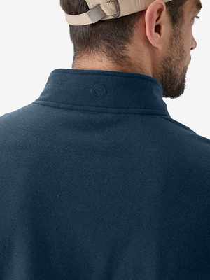Close-up view of the logo on the back of the navy pullover