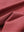 Close-up texture of brick red waffle texture 1/4 zip pullover fabric showing detailed waffle knit material and weave.