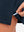 Hem stitching detail close-up in navy of women's lightweight golf dress with 2 pockets.
