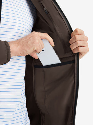 Detail view of inner pocket on coffee brown warm puffer winter golf jacket