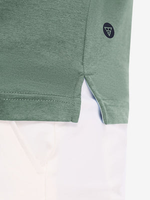 Hem detail close-up in celadon green heather of performance heather contrast collar polo shirts.