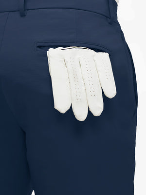 Detail view of back pocket on dark blue flat front flex cotton blend golf shorts