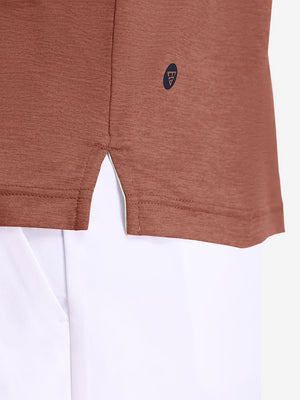 Hem detail close-up in red ochre heather of performance heather contrast collar polo shirts.