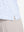 Detail view of hem on white blue florals women's sleeveless q-zip print quick dry golf tops